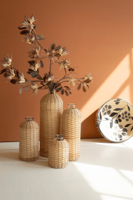 SET OF FOUR RATTAN WRAPPED GLASS VASES